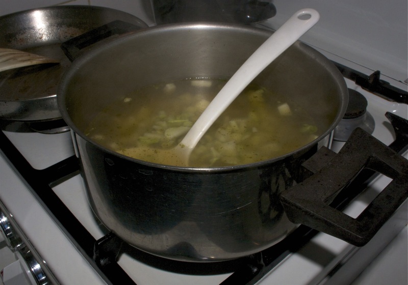 Put the pan with broccoli stems and water on a stove on high heat, add a vegetable stock cube and bring it to a boil